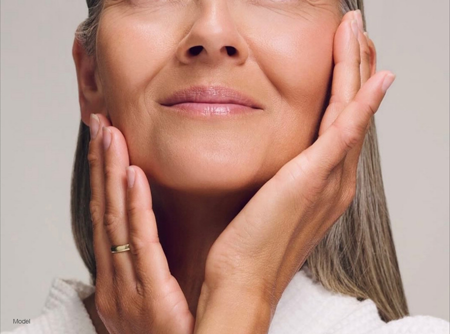 Mature woman touching her face