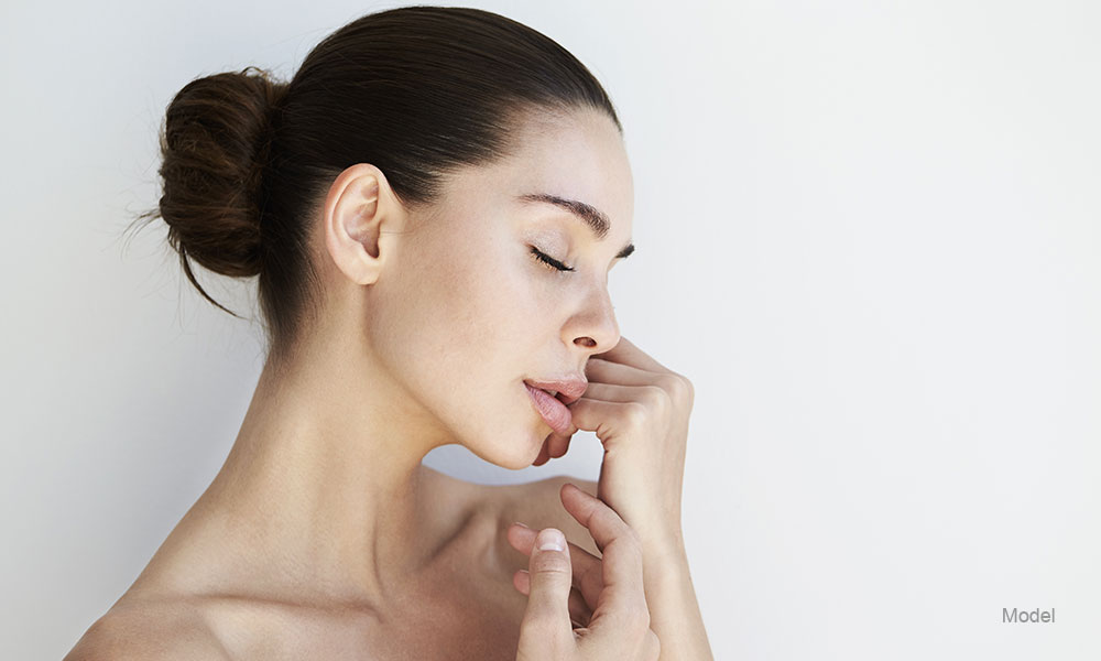 Woman touching her chin with her hand