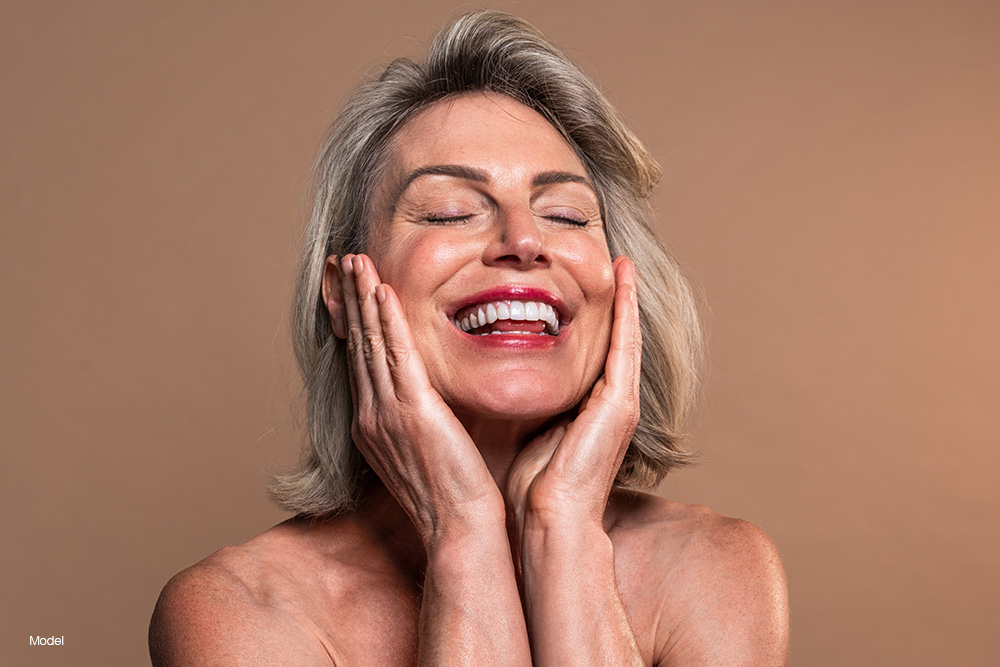 Mature woman touching her face