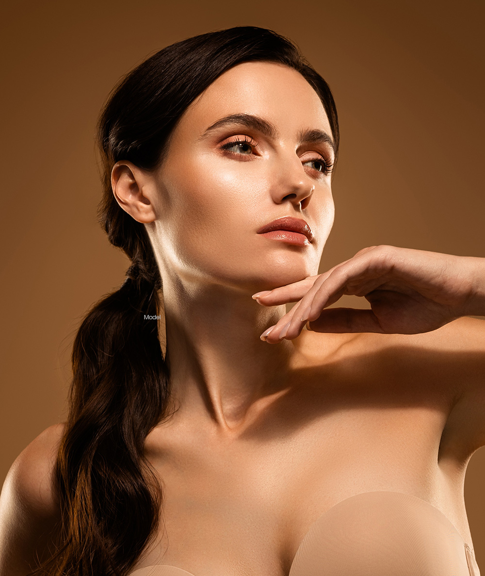 neck-lift-procedure-model Woman touching her neck