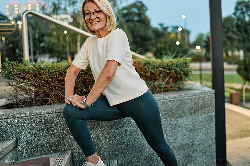 Woman stretching on some steps 