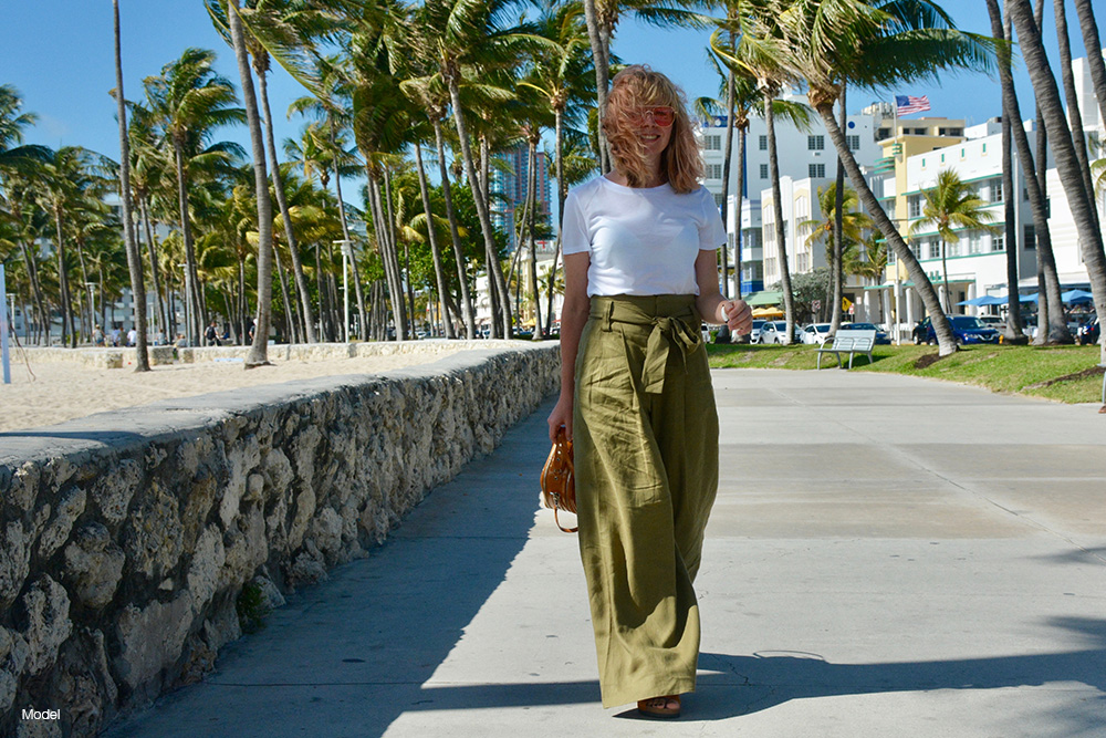 A woman walking along a mimai beach